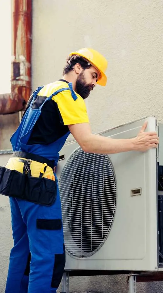 Technician servicing an air conditioner